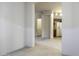 Hallway leading to laundry room and kitchen with neutral colored walls at 3864 W Fairway Dr, Eloy, AZ 85131