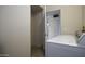 Functional laundry room with washer and dryer, adjacent to open hallway at 3864 W Fairway Dr, Eloy, AZ 85131