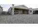 Back patio with dining area and gravel-covered backyard at 3864 W Fairway Dr, Eloy, AZ 85131