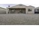 Rear exterior of home with covered patio and gravel yard at 3864 W Fairway Dr, Eloy, AZ 85131