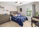 Cozy bedroom with a blue star-patterned quilt, a ceiling fan, and natural light from the window at 4225 N 42Nd St, Phoenix, AZ 85018