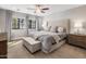 Bedroom featuring a large upholstered bed, a bench, and natural light from two windows at 4225 N 42Nd St, Phoenix, AZ 85018