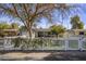 Charming home featuring a white picket fence and mature trees shading the front yard at 4225 N 42Nd St, Phoenix, AZ 85018