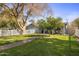 Well-manicured front lawn leads to this home, complemented by trees and a charming white picket fence at 4225 N 42Nd St, Phoenix, AZ 85018