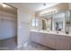 Bright bathroom featuring double sinks, large mirrors, and neutral tones, with access to a walk-in closet and toilet room at 4228 E Desert Sky Ct, Cave Creek, AZ 85331