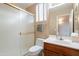 Cozy bathroom area with a toilet, sink with wood cabinets, a frosted glass sliding door, and natural light at 4228 E Desert Sky Ct, Cave Creek, AZ 85331