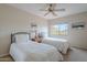 Neutral bedroom features two twin beds, a ceiling fan, and a window at 4228 E Desert Sky Ct, Cave Creek, AZ 85331