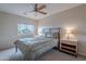 Bright bedroom with a ceiling fan, window, and a comfortable bed with side tables and lamps at 4228 E Desert Sky Ct, Cave Creek, AZ 85331