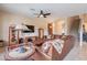 Inviting living room with a leather sectional sofa, ceiling fan, and convenient access to the kitchen at 4228 E Desert Sky Ct, Cave Creek, AZ 85331