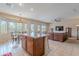 Open concept living room with tile flooring, a kitchen island, and a comfortable leather sofa at 4228 E Desert Sky Ct, Cave Creek, AZ 85331