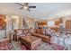 Open-concept living room with easy access to kitchen, a large leather sofa and open floorplan at 4228 E Desert Sky Ct, Cave Creek, AZ 85331