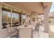 Covered patio area with outdoor seating, a stone table, a grill, and views of the pool at 4228 E Desert Sky Ct, Cave Creek, AZ 85331