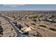 Aerial view of a golf course community featuring lush greens and luxury homes, mountains are visible in the distance at 42829 W Oakland Dr, Maricopa, AZ 85138