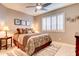 Cozy bedroom featuring a ceiling fan, shuttered window, and neutral color palette at 42829 W Oakland Dr, Maricopa, AZ 85138