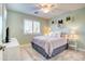 Comfortable bedroom featuring a ceiling fan, shuttered window, and carpeted floors at 42829 W Oakland Dr, Maricopa, AZ 85138