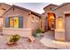 Close up of a charming home's entrance showcasing well manicured front yard and inviting doorway at 42829 W Oakland Dr, Maricopa, AZ 85138