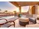 Outdoor covered patio area with a pool and desert landscape in the background at 42829 W Oakland Dr, Maricopa, AZ 85138