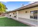 Backyard patio area with lush green grass, covered patio, and direct access to the home at 4312 W Paradise Dr, Glendale, AZ 85304