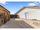 Exterior view of detached garage, backyard with concrete flooring, and a partially shaded area at 4312 W Paradise Dr, Glendale, AZ 85304