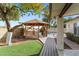 Backyard featuring gazebo, artificial turf, and a view of the sparkling in-ground pool at 4312 W Paradise Dr, Glendale, AZ 85304