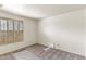 Bright bedroom featuring neutral carpet, crisp white walls, and shuttered window at 4312 W Paradise Dr, Glendale, AZ 85304