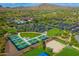 Aerial view of community amenities featuring tennis courts, pool, water park, and surrounding landscape at 44025 N 44Th Ln, New River, AZ 85087