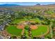 Aerial view of community baseball fields, lakes, and surrounding mountain landscape at 44025 N 44Th Ln, New River, AZ 85087