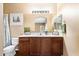 Charming bathroom featuring vanity with dark wood cabinets and decorative accents at 44025 N 44Th Ln, New River, AZ 85087