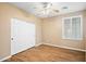 Bedroom with wood floors, ceiling fan, large closet and plantation shuttered window at 44025 N 44Th Ln, New River, AZ 85087