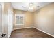 Cozy bedroom features wood floors, a ceiling fan and window with shutter blinds at 44025 N 44Th Ln, New River, AZ 85087