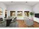 Bright dining area with a glass table and views of the landscaped backyard through three large windows at 44025 N 44Th Ln, New River, AZ 85087