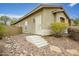 Back exterior of home featuring a block wall and gravel landscaping at 44025 N 44Th Ln, New River, AZ 85087