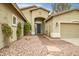 Inviting home exterior featuring a well-manicured front yard and a two-car garage at 44025 N 44Th Ln, New River, AZ 85087