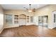 Spacious living room with wood floors, built-in shelving and sliding glass doors at 44025 N 44Th Ln, New River, AZ 85087