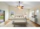 Bright main bedroom with a ceiling fan, wood floors, and light colored decor at 44025 N 44Th Ln, New River, AZ 85087