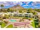 Community aerial view showcasing a pool, lush landscaping, and stunning mountain views at 4610 N 68Th St # 416, Scottsdale, AZ 85251