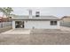 The backyard with desert landscaping, a small patio, and a view of the house's exterior at 4814 E Pearce Rd, Phoenix, AZ 85044