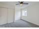 Bedroom featuring neutral walls, gray carpet, a ceiling fan, and a window at 4814 E Pearce Rd, Phoenix, AZ 85044