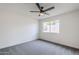 Bedroom featuring neutral walls, gray carpet, a ceiling fan, and a window at 4814 E Pearce Rd, Phoenix, AZ 85044