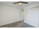 Bedroom featuring neutral walls, gray carpet, a ceiling fan, and a sliding door closet at 4814 E Pearce Rd, Phoenix, AZ 85044