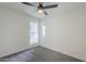 Bedroom featuring neutral walls, gray carpet, a ceiling fan, and a window at 4814 E Pearce Rd, Phoenix, AZ 85044