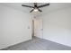 Bedroom featuring neutral walls, gray carpet, a ceiling fan, and a door at 4814 E Pearce Rd, Phoenix, AZ 85044