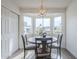 Inviting dining area with large windows, stylish light fixture, and seating for four at 4814 E Pearce Rd, Phoenix, AZ 85044