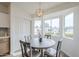 Bright dining area features natural light, pendant lighting, and seating for four at 4814 E Pearce Rd, Phoenix, AZ 85044