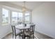 Cozy dining area with bay window, stylish lighting, and seating for four at 4814 E Pearce Rd, Phoenix, AZ 85044