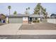 Charming single-story home featuring desert landscaping and a two-car attached garage at 4814 E Pearce Rd, Phoenix, AZ 85044