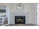 Close up of a brick fireplace with a black mirror and white accents at 4814 E Pearce Rd, Phoenix, AZ 85044