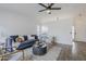 Open-concept living room with ceiling fan and seamless flow to the kitchen at 4814 E Pearce Rd, Phoenix, AZ 85044