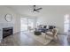 Bright living room with a fireplace, ceiling fan, wood-look floors and sliding glass doors to the backyard at 4814 E Pearce Rd, Phoenix, AZ 85044