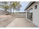 Back patio with desert landscaping and view into living room through sliding glass door at 4814 E Pearce Rd, Phoenix, AZ 85044